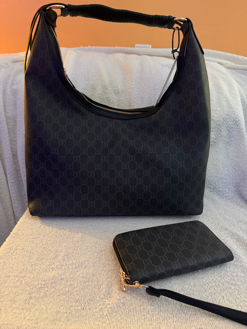 Black monogram GG hobo bag set with matching wristlet wallet - front view