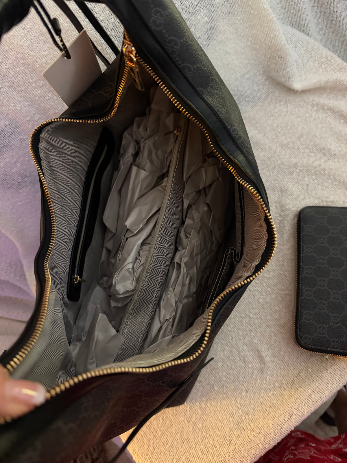 Black monogram GG hobo bag interior showing zip lining and compartments