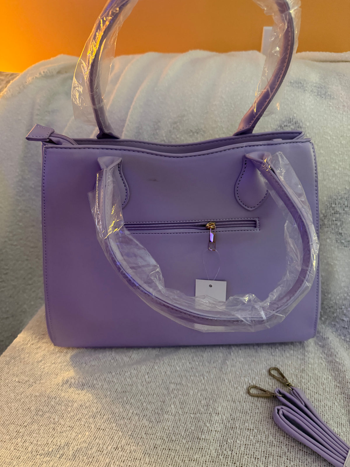 Back view of lavender purple tote bag showing exterior zip pocket